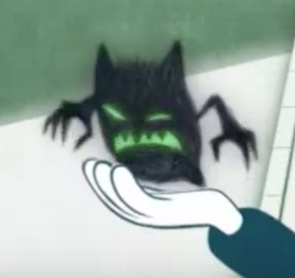 Cartoon hand holding out a black monster with green eyes and mouth