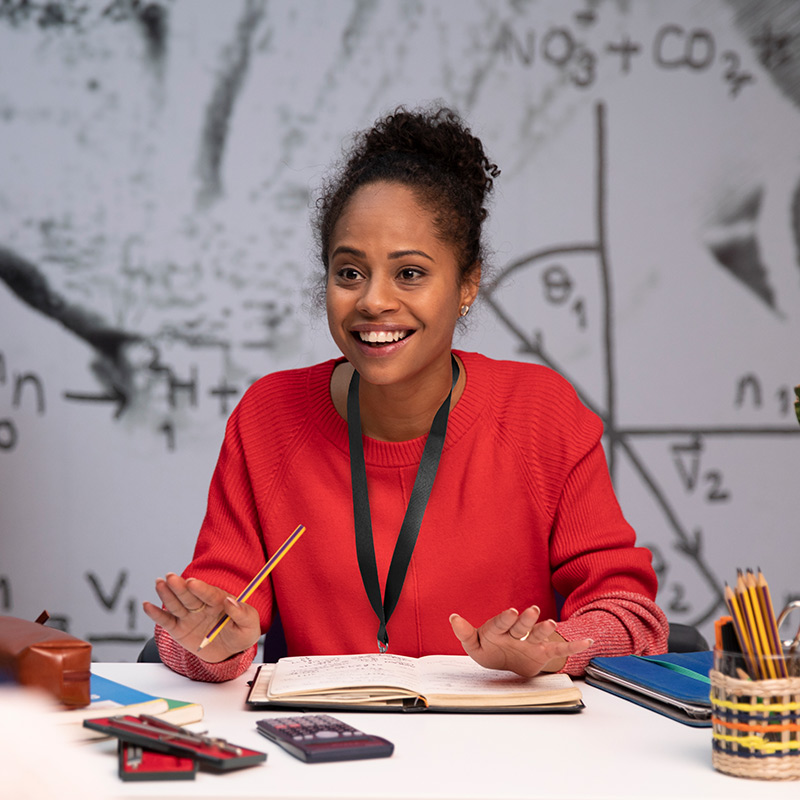 Photo of teacher at desk