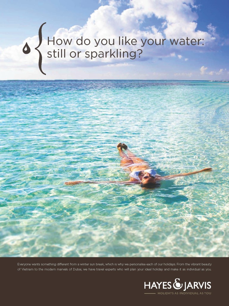 Woman laying back in clear blue water in a white bikini ad campaign