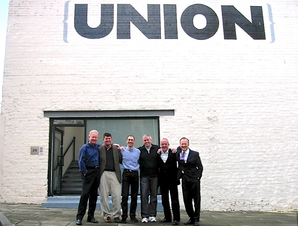 group on men in a line outside a building with Union written on it