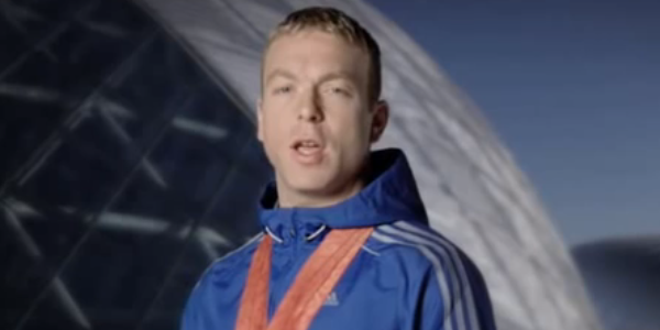 Man in blue track suit standing looking at camera 