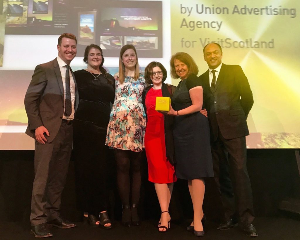 Visit Scotland team, group photo on stage accepting award