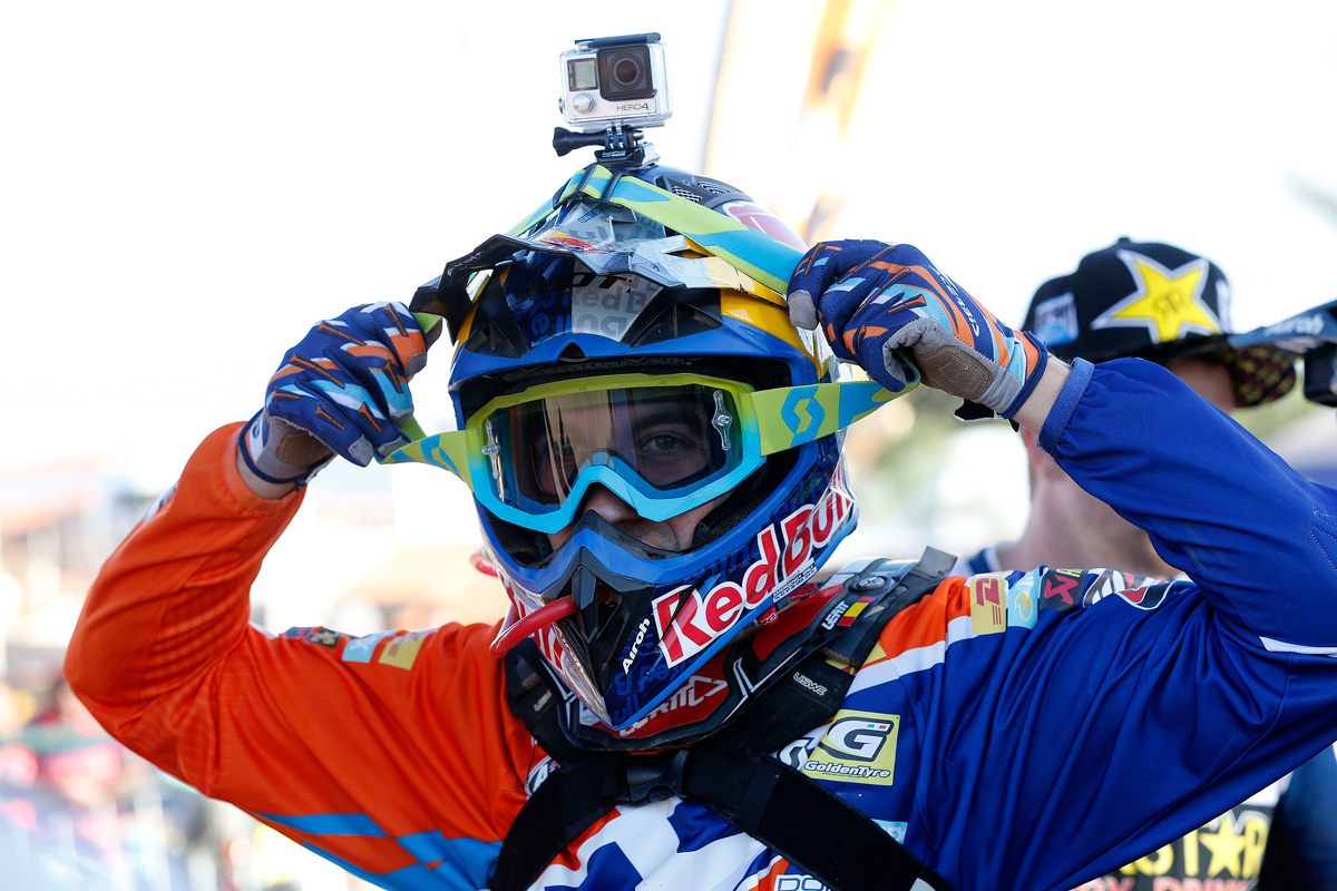 Red Bull motorbike rider putting on gopro onto helmet