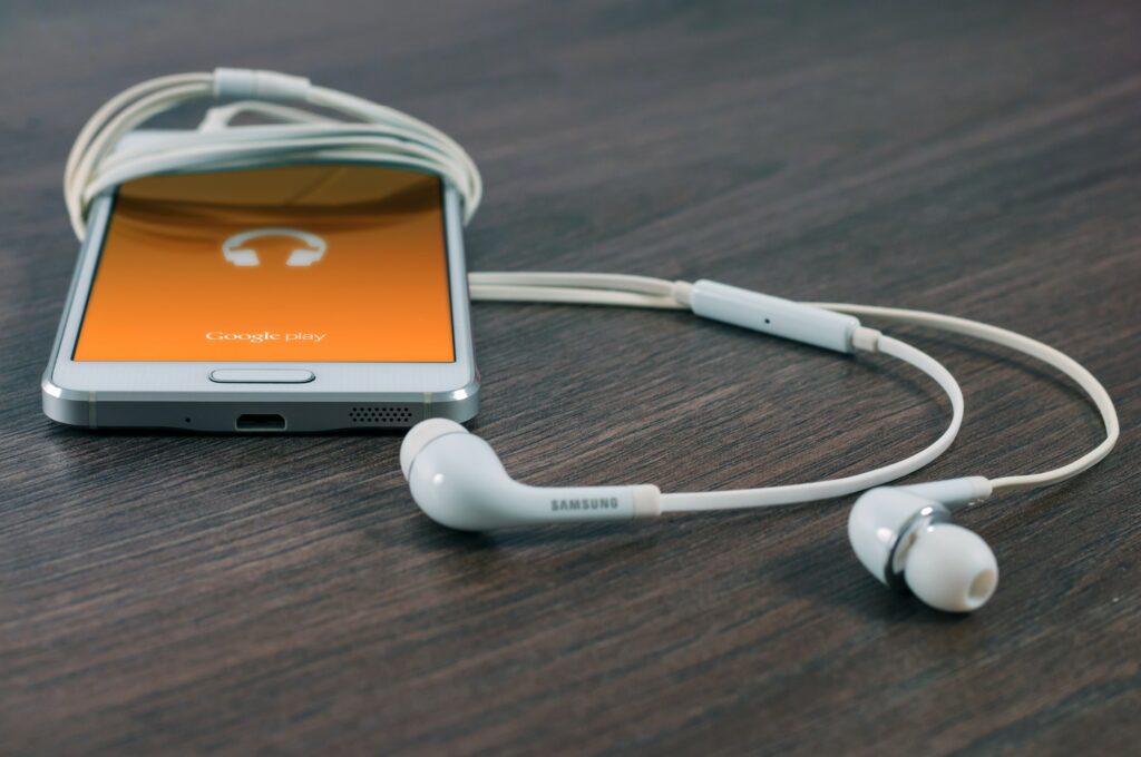 Phone on table with ear phones plugged in