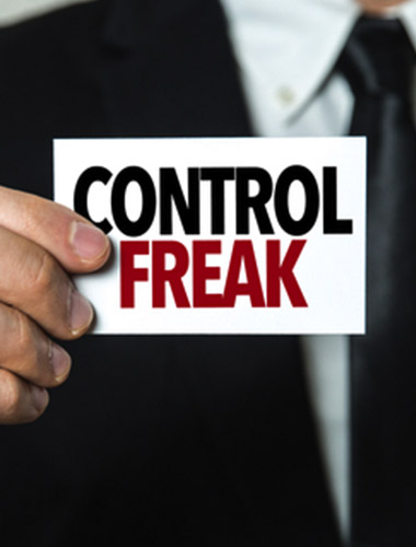 Man holding up sign "Control Freak"