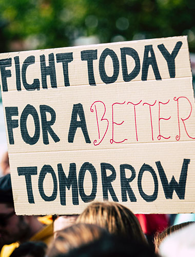 Banner held up on cardboard, with message written on it "Fight today for a better tomorrow""