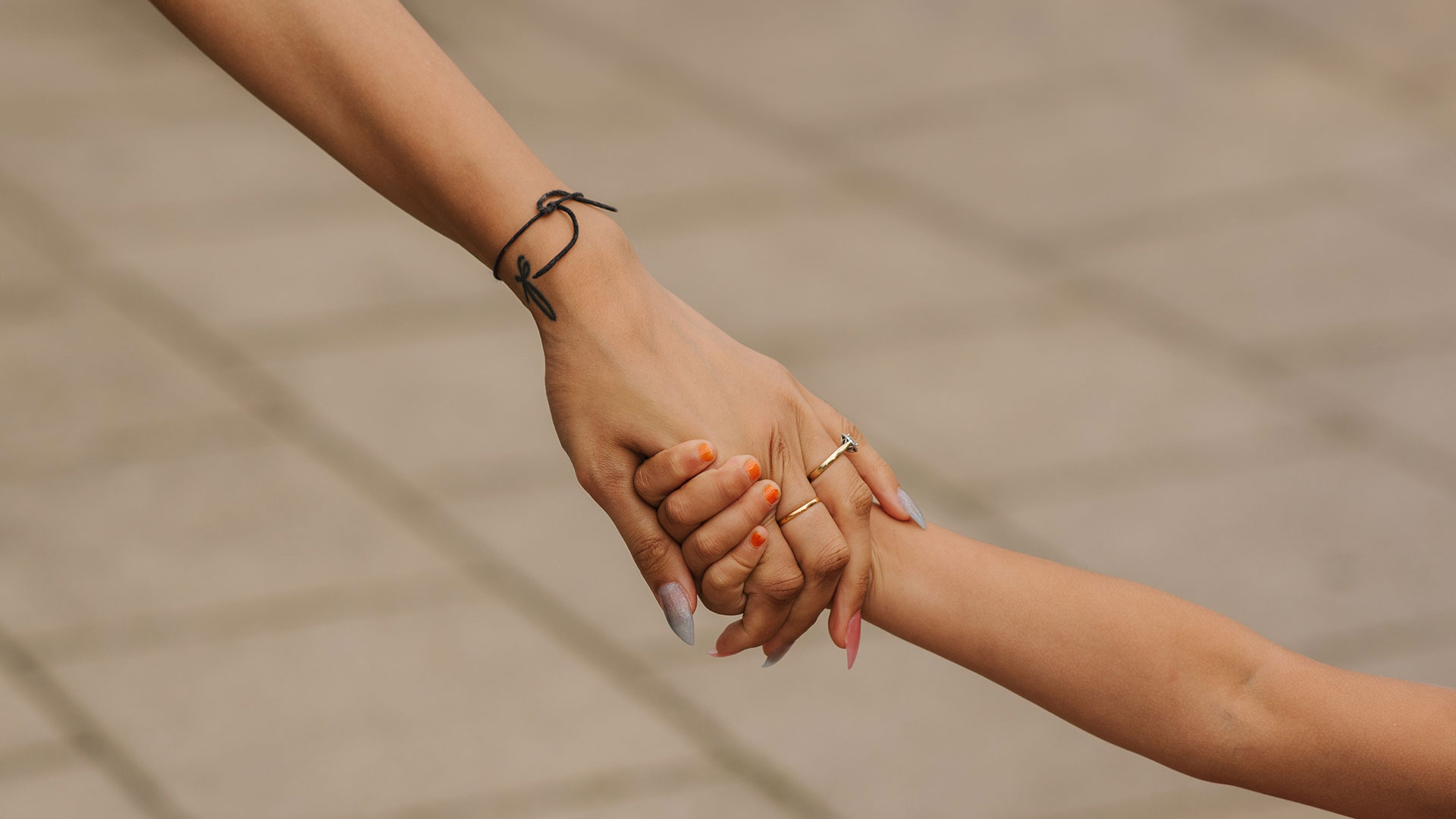 Woman and child holding hands