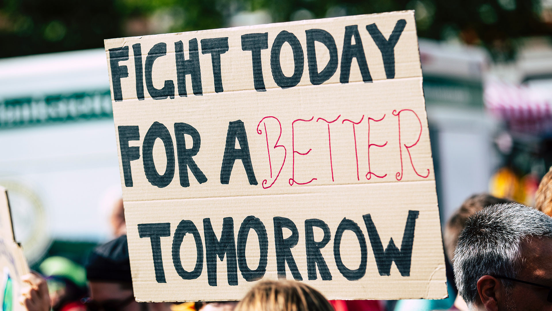 Banner held up on cardboard, with message written on it "Fight today for a better tomorrow""