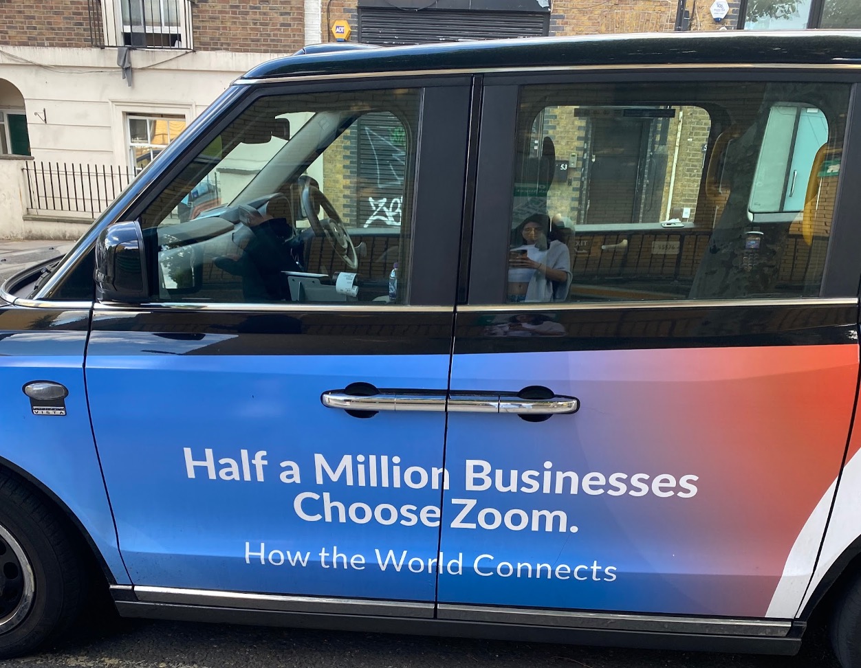 Taxi cab with ad on side of the car