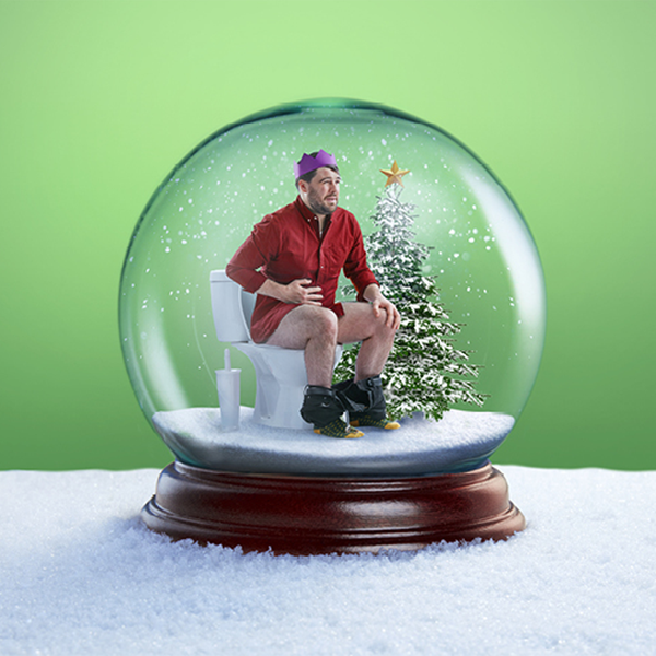 Man on toilet within a snow-globe