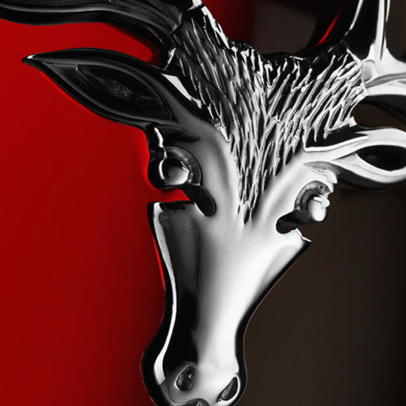 Stag head in silver on red background