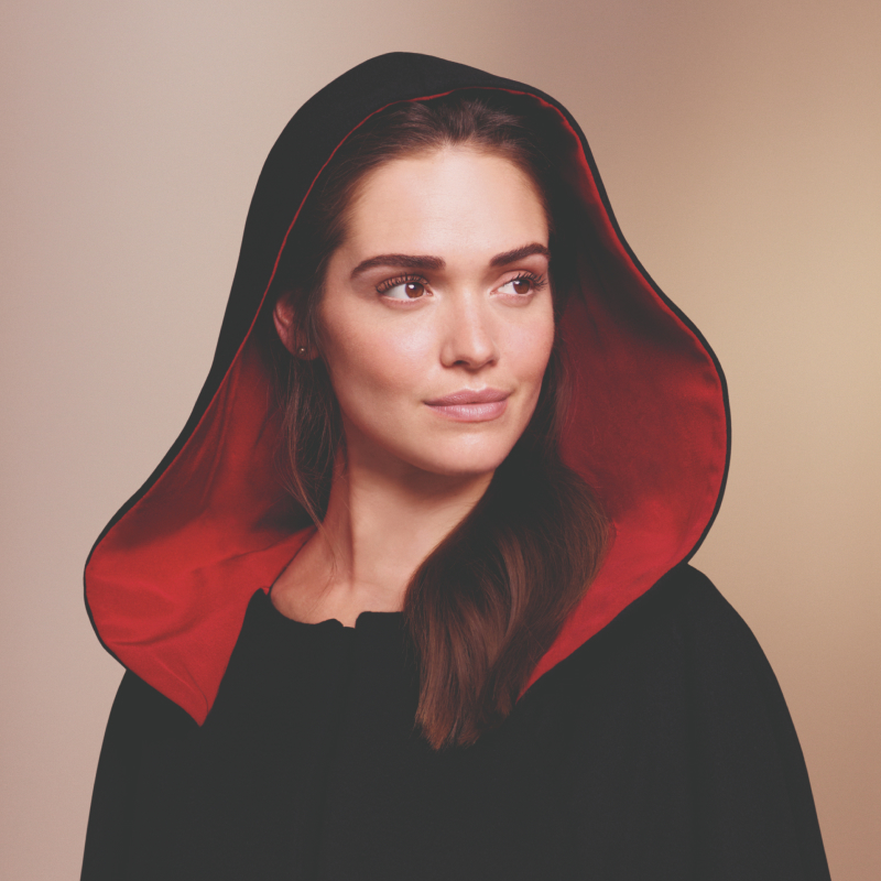 Woman in black cloak with red lining 