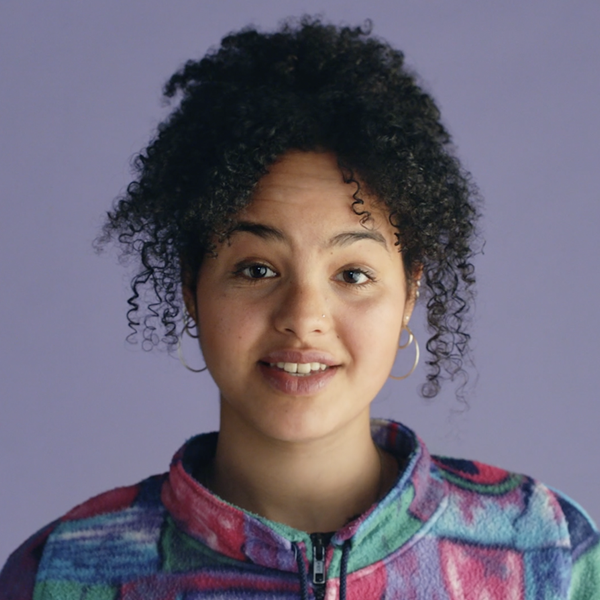 Woman looking to camera, on a purple background