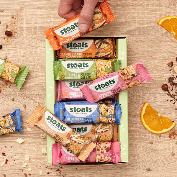 Box of stoats bars and a hand picking one up