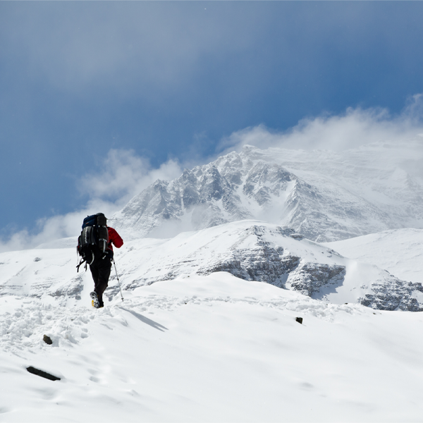 Man hill walking in the mountain snow