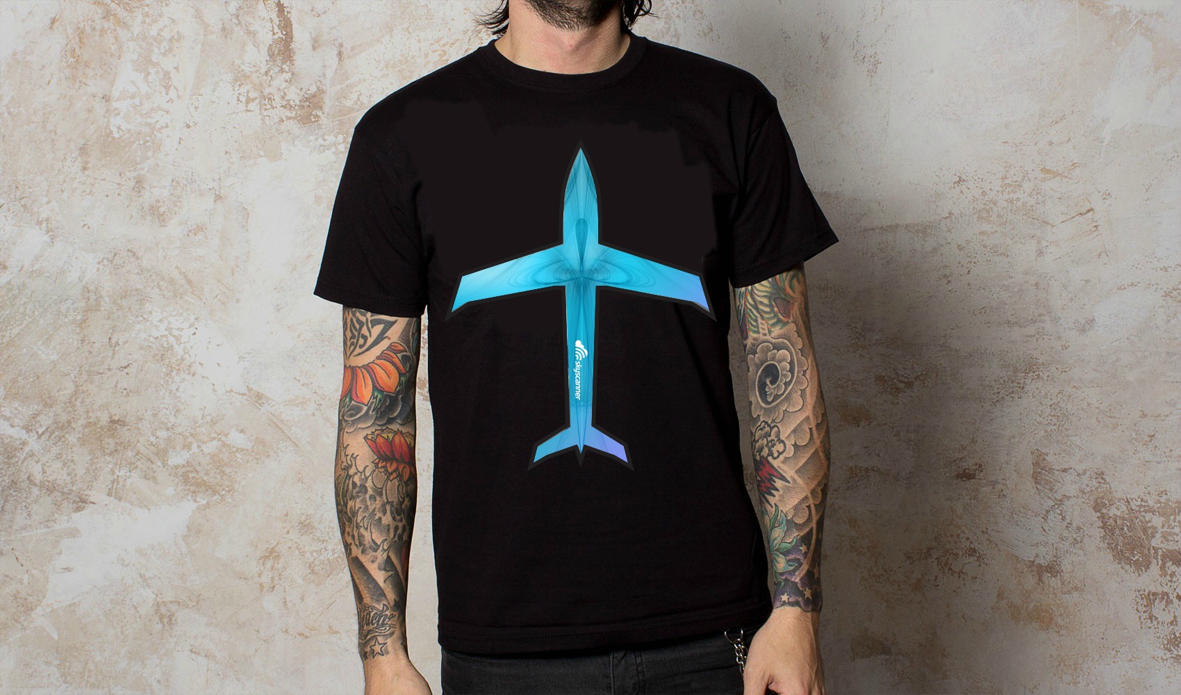 Man wearing t-shirt with logo of paper aeroplane on it