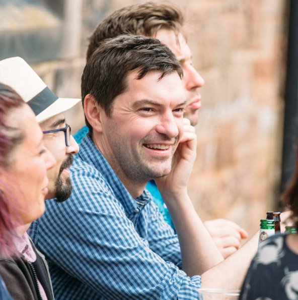 group of people sitting outside chatting