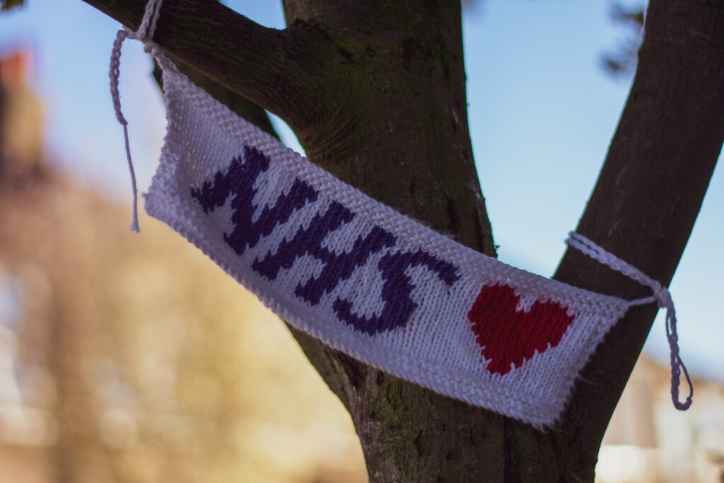 Knitted NHS message attached to tree