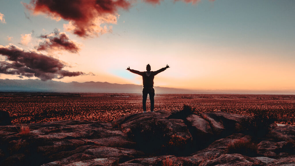 Man standing in front of a sunrise