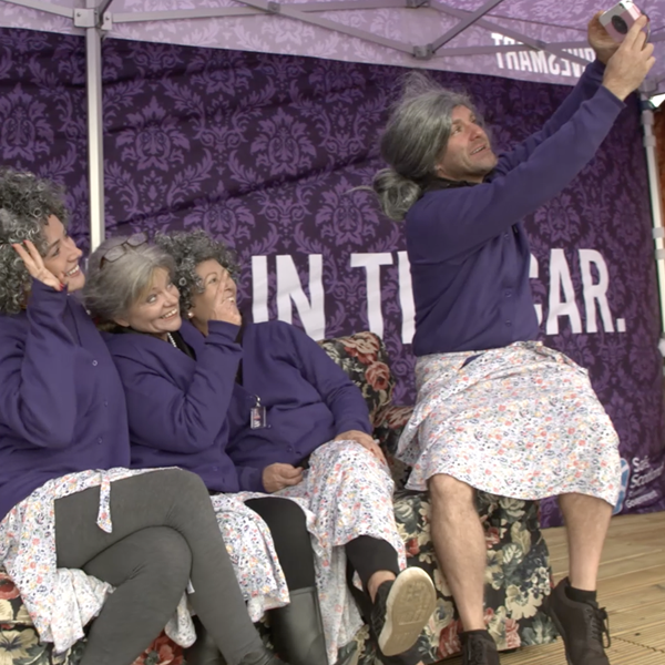 Men and Women dressed up like old ladies on a stage