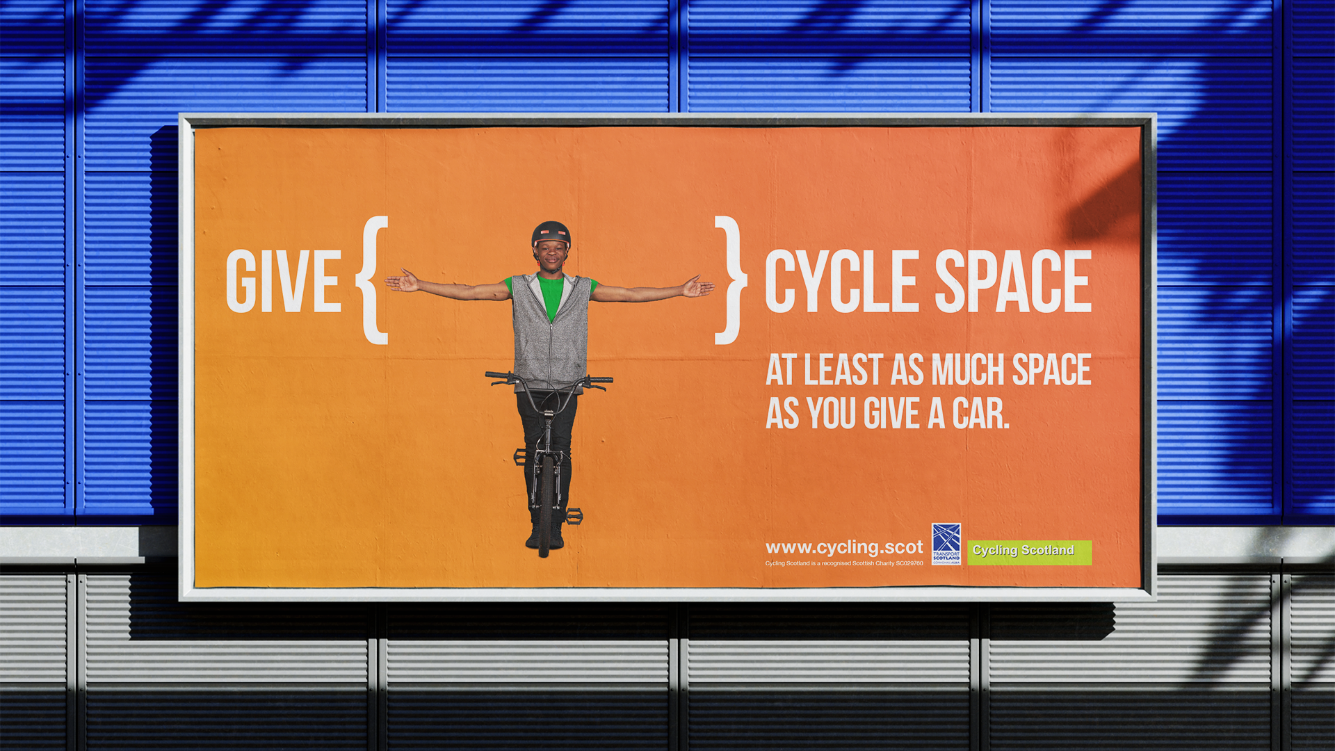 Billboard poster of ad with a young teen on bike with arms stretched out