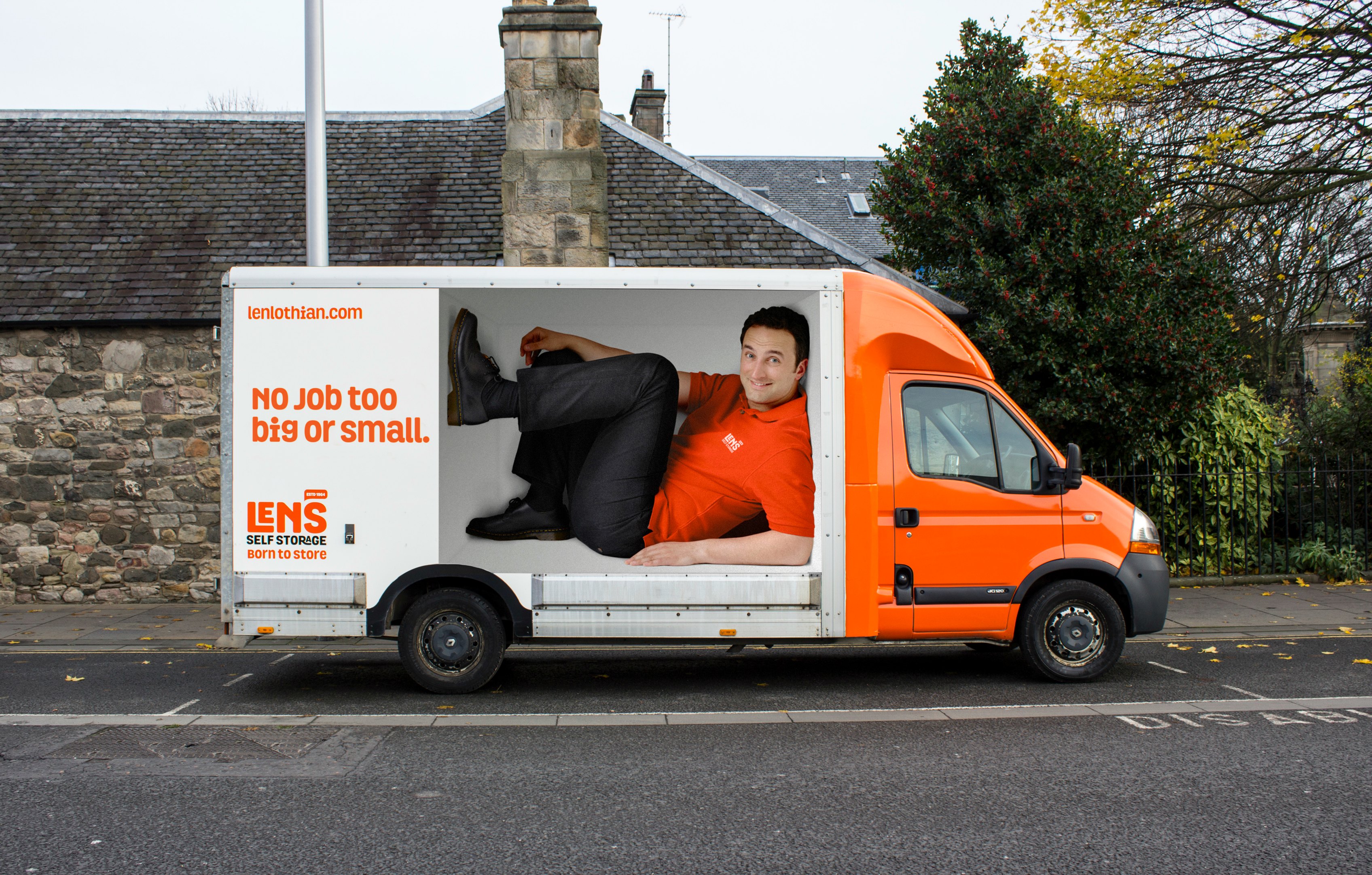 Van decal with a man on the side of the van fro Len storage