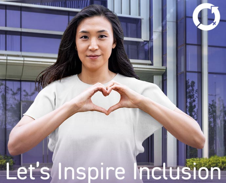 Woman in a white t-shirt doing a heart symbol with her hands