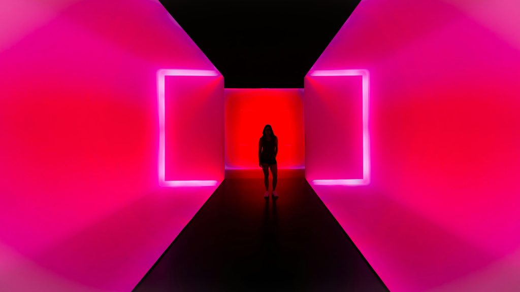 Woman in a pink neon corridor