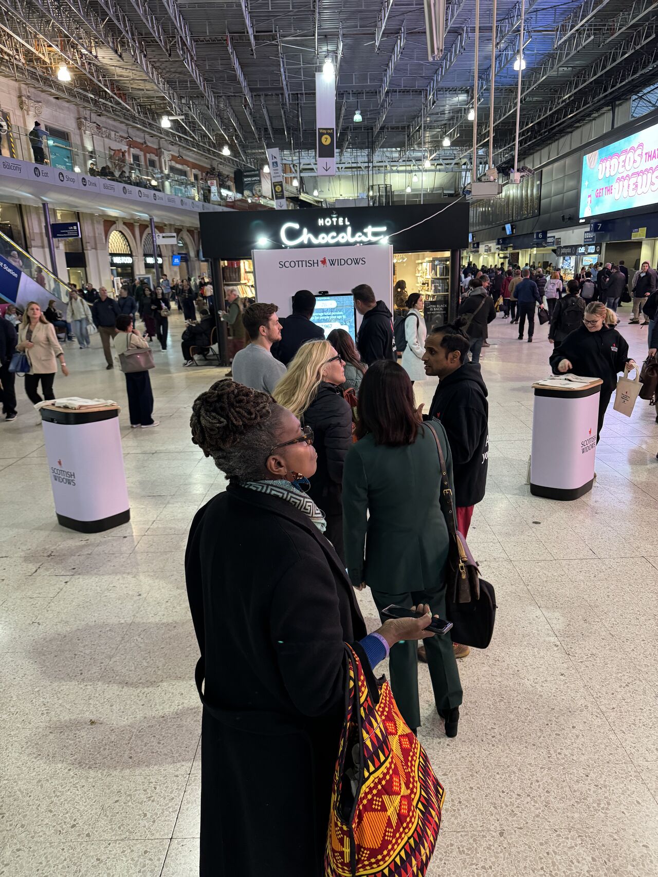 Queue of people waiting to use the display display stand